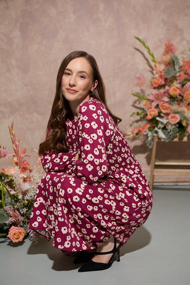 Women's petite autumn smocked midi dress with modern poppy print on a plum base