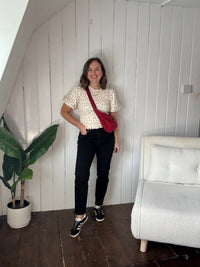 Size 12 model wearing black petite jeans styled casually