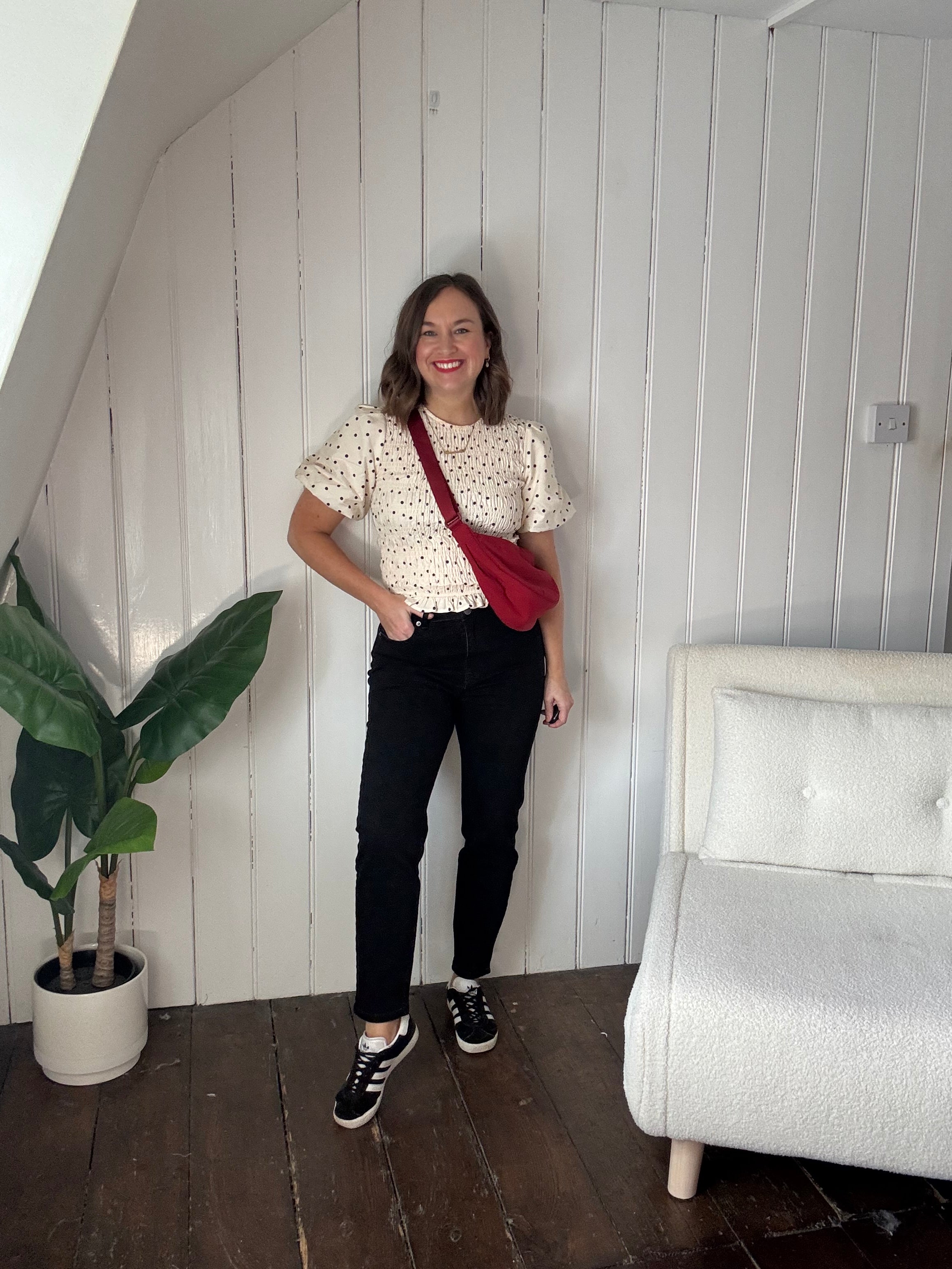Size 12 model wearing black petite jeans styled casually