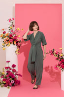 Wide leg, short sleeve petite jumpsuit in green, worn by model walking
