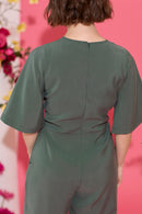 Wide leg, short sleeve petite jumpsuit in green, worn by model, back view close up