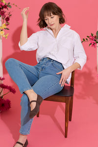 Slim, straight, high rise blue petite jeans worn by model sat down