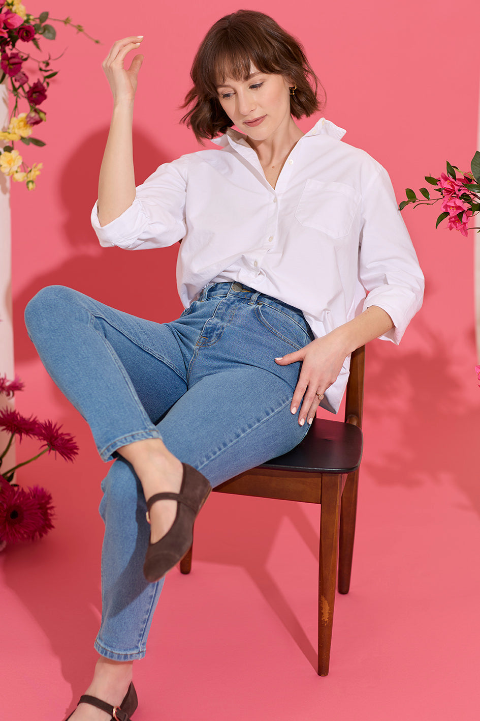 Slim, straight, high rise blue petite jeans worn by model sat down