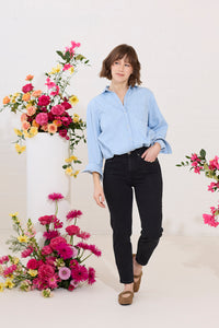 Slim, straight, high rise black petite jeans worn by model