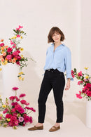 Slim, straight, high rise black petite jeans worn by model