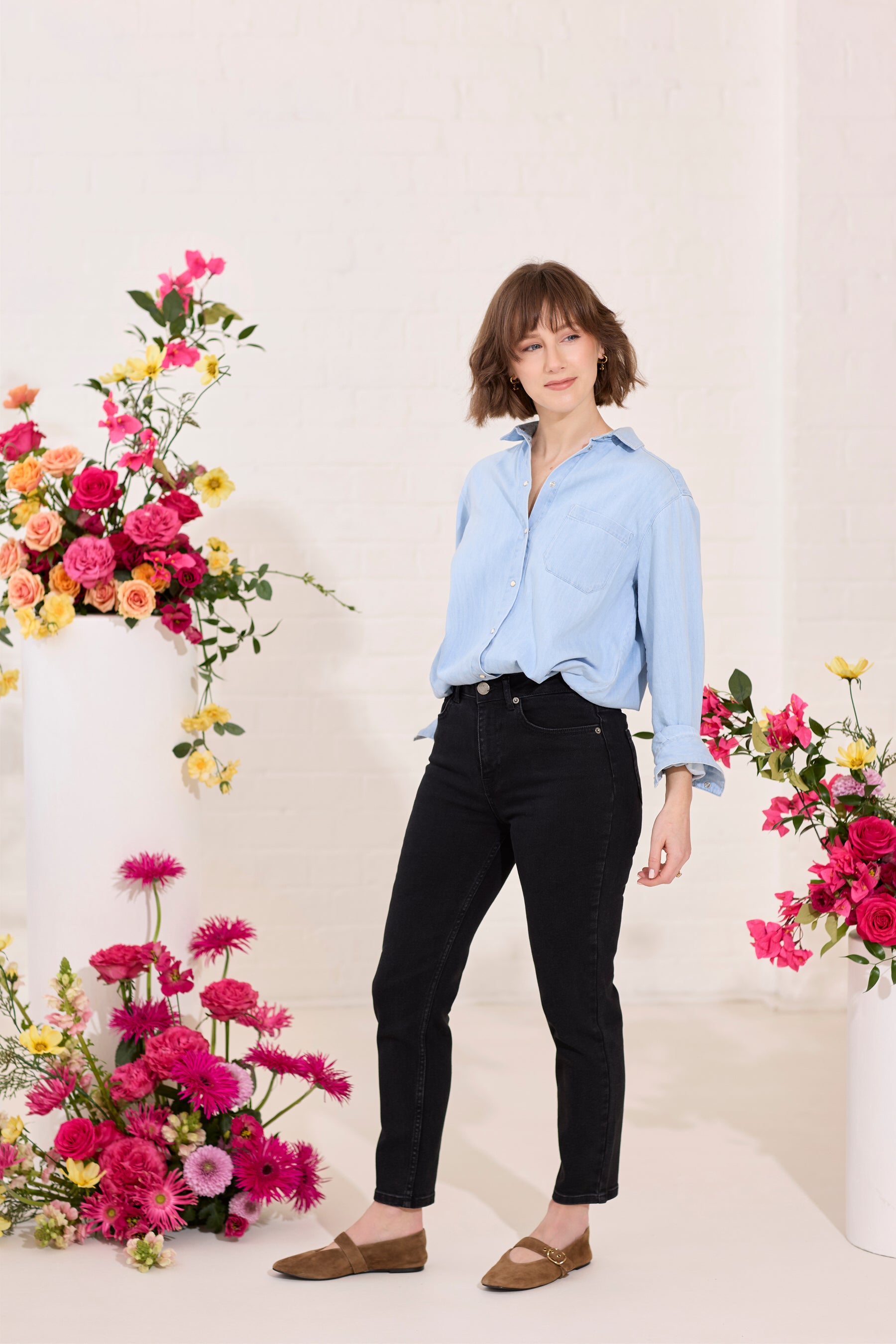 Slim, straight, high rise black petite jeans worn by model