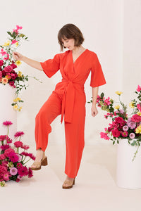 Wide leg, short sleeve petite jumpsuit in red, worn by model dancing