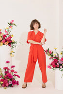Wide leg, short sleeve petite jumpsuit in red, worn by model standing