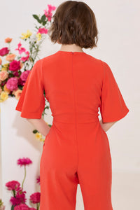 Wide leg, short sleeve petite jumpsuit in red, worn by model, back view
