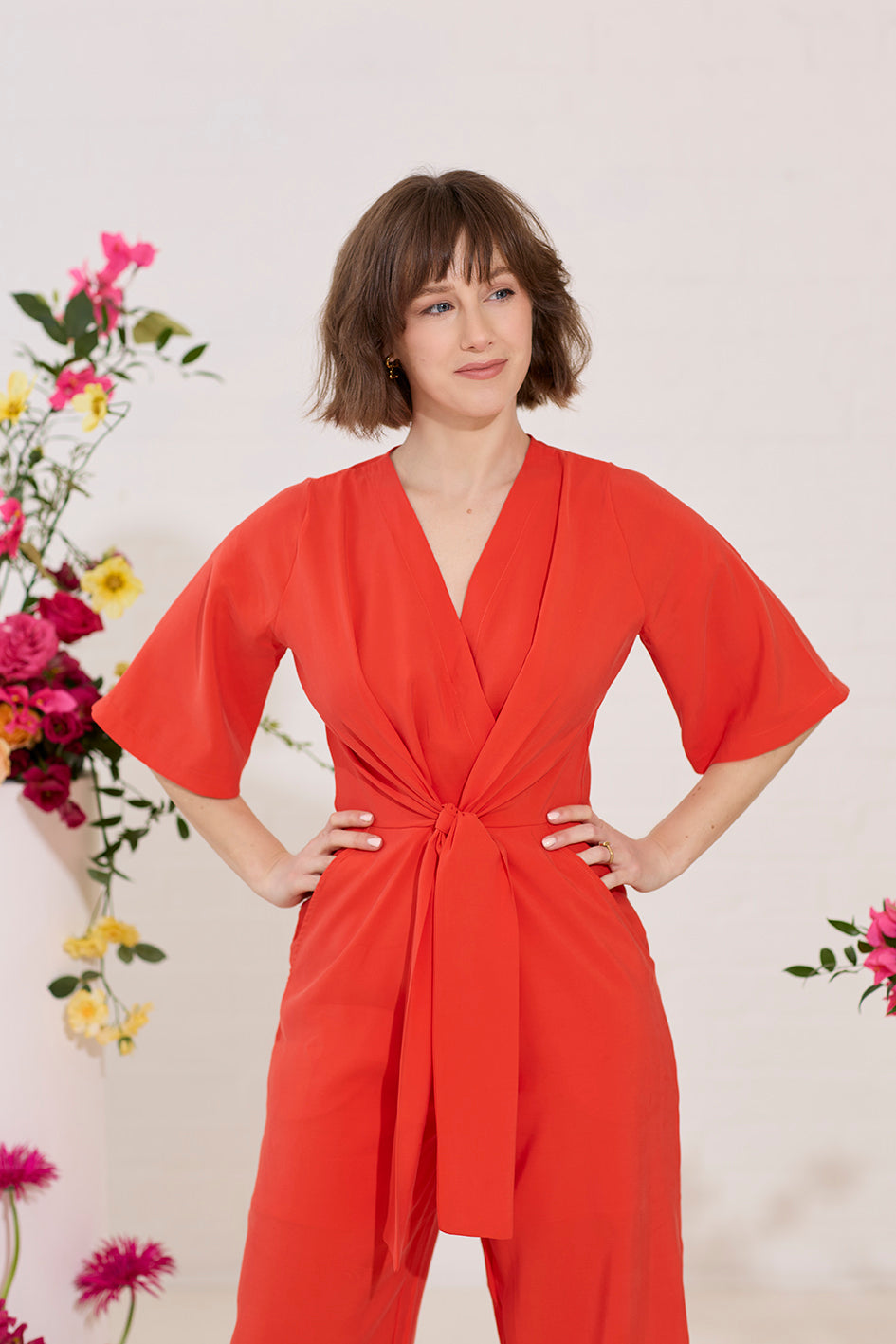 Wide leg, short sleeve petite jumpsuit in red, worn by model close up front view