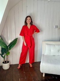 Size 12 model wearing red petite wedding guest jumpsuit 