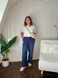 Size 12 model wearing petite navy wide leg summer trousers styled casually